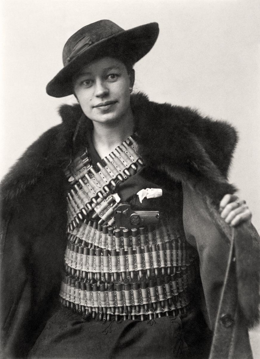 Verna Eriksson, smuggler for the Whites in the Finnish Civil War, poses with some contraband weaponry, 1918