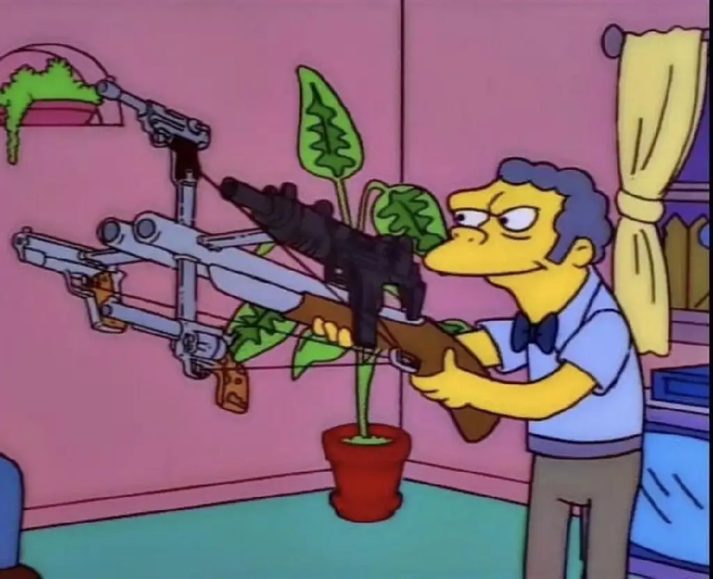 Moe from the Simpsons holding five guns rigged to fire simultaneously