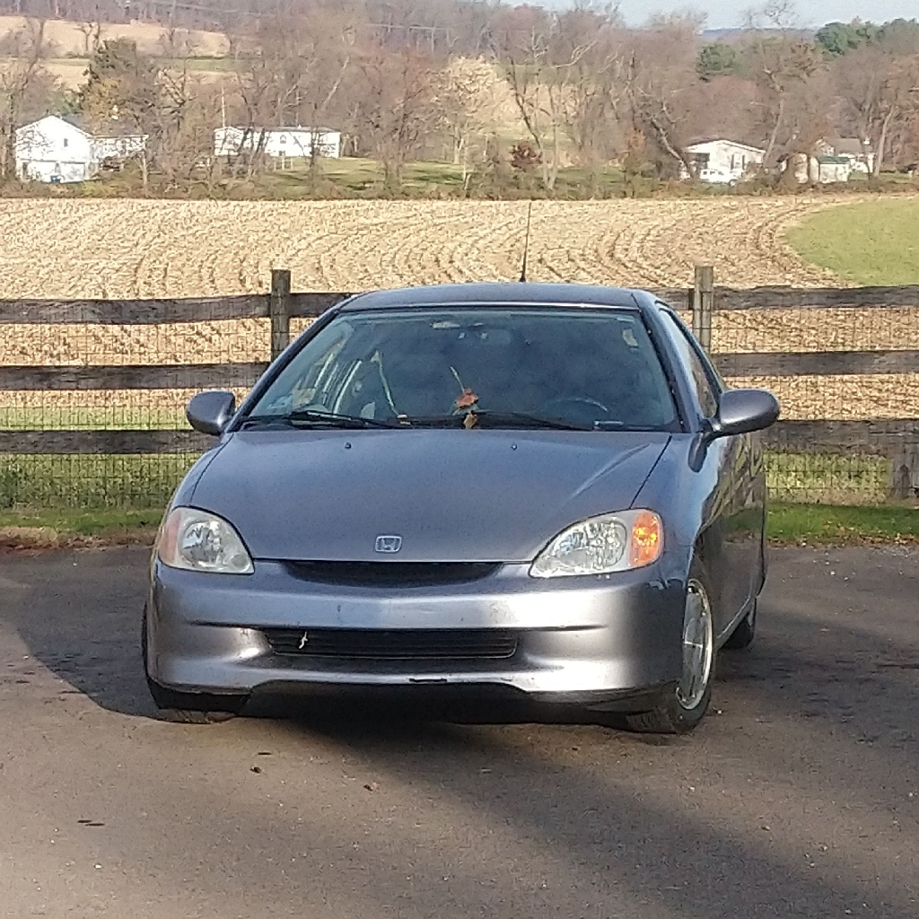 a photograph of a silver 2000 Honda Insight.