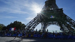 A man is seen climbing the Eiffel Tower, prompting an evacuation hours before closing ceremony