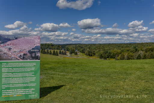 View from the lawn towards the stage area.  Sign shows a photo of the crowd along with locations of the prominent landmarks.