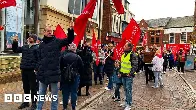 Striking food factory workers march through town