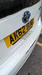 A shelf below a car's license plate [solved]