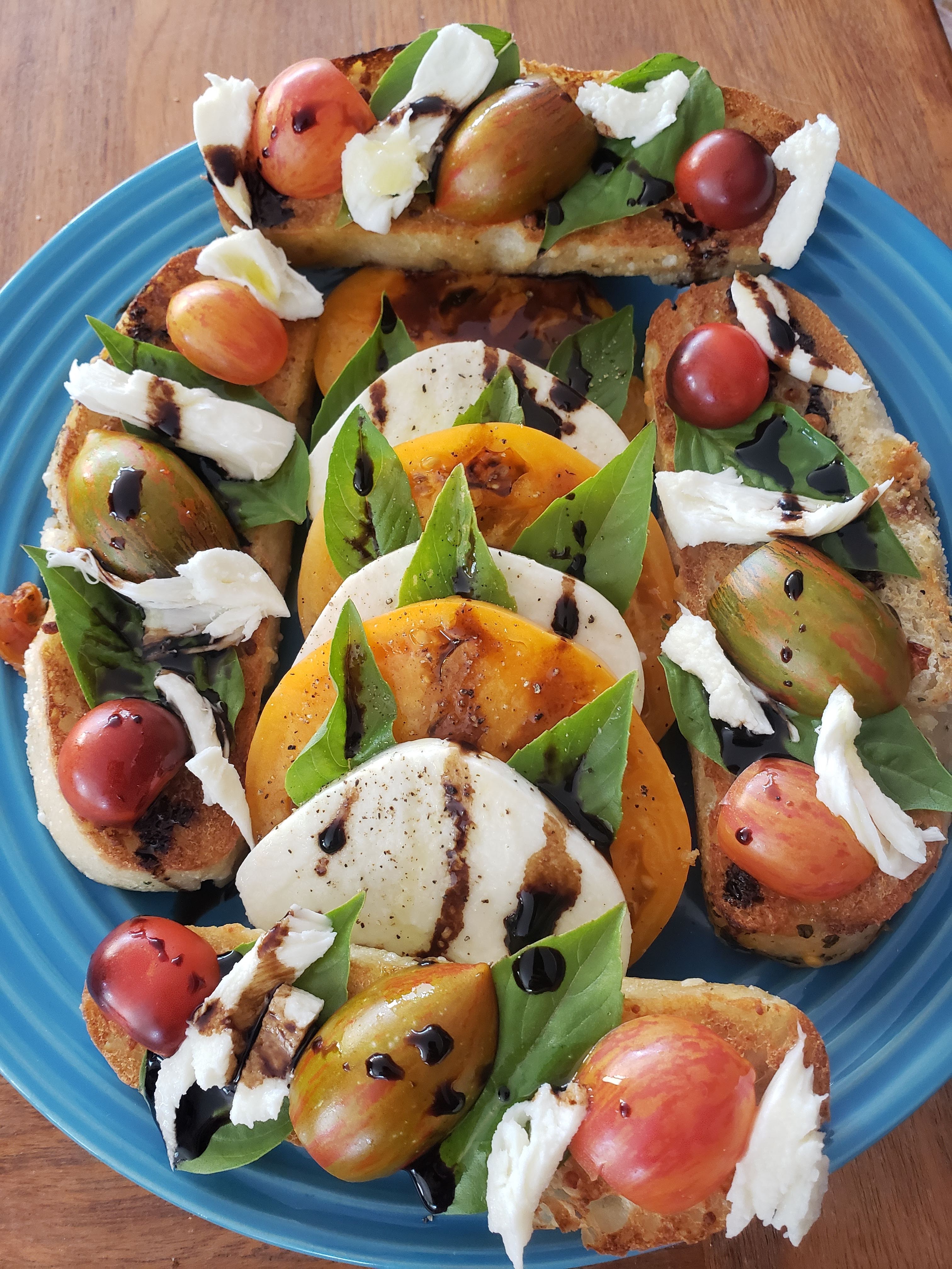 My favorite way to eat tomatoes, on toasted sourdough with fresh basil and mozzarella, topped with balsamic glaze