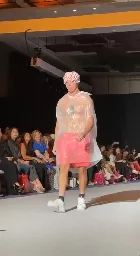 At NY Fashion Week, someone snuck on the runway wearing a trash bag and a shower cap.