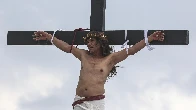 A Filipino villager is nailed to a cross for the 35th time on Good Friday to pray for world peace