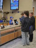 A literal child taking orders in a fast food restaurant in the US