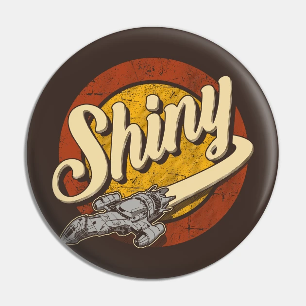 A round button with concentric rings and the word "Shiny" in the middle, with the word's letter 'y' become the engine trail from the spaceship Serenity from the sci fi show firefly