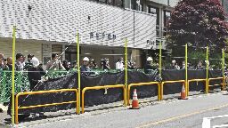 Japanese town overrun with tourists puts up view-blocking barrier near Mount Fuji | CNN