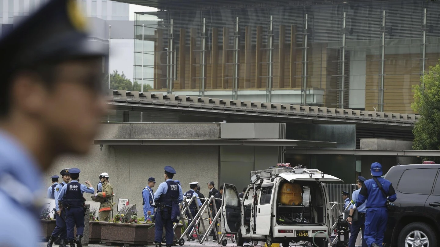 Japan's ruling party headquarters is attacked with firebombs and suspect is arrested, media report