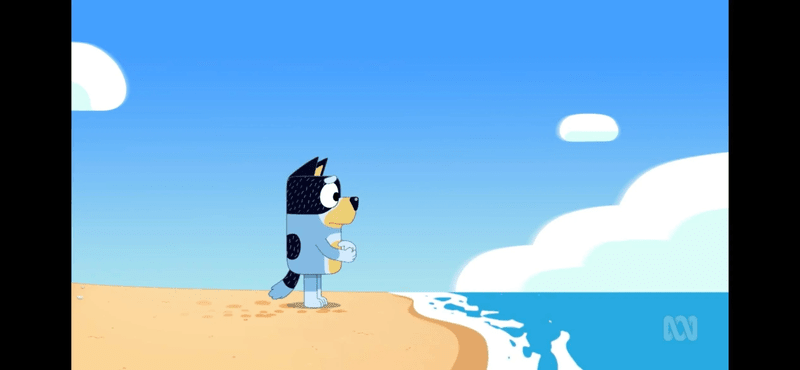 Bandit from Bluey staring solemnly at the ocean