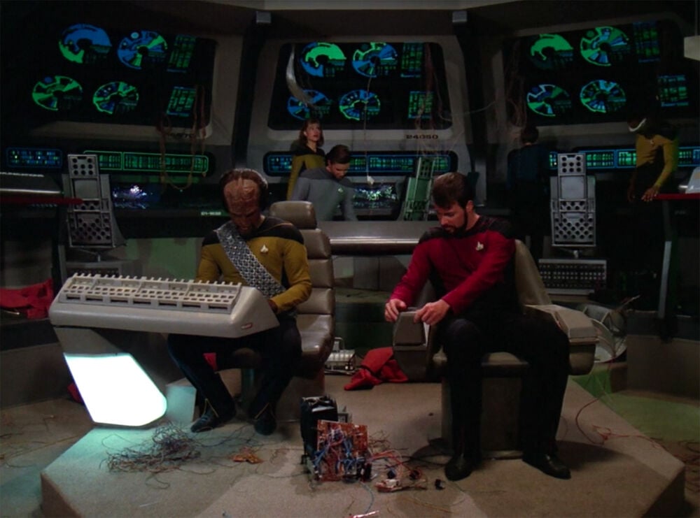 Commander Riker and Lieutenant Worf on the bridge of the USS Hathaway, attempting to repair the ship in time for battle simulations.