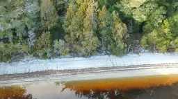 Mystery 'HELP' message appears in the sand at West Coast lake