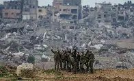 Israeli soldiers pose for a photograph on the Gaza Strip border  Photograph: Tsafrir Abayov/AP