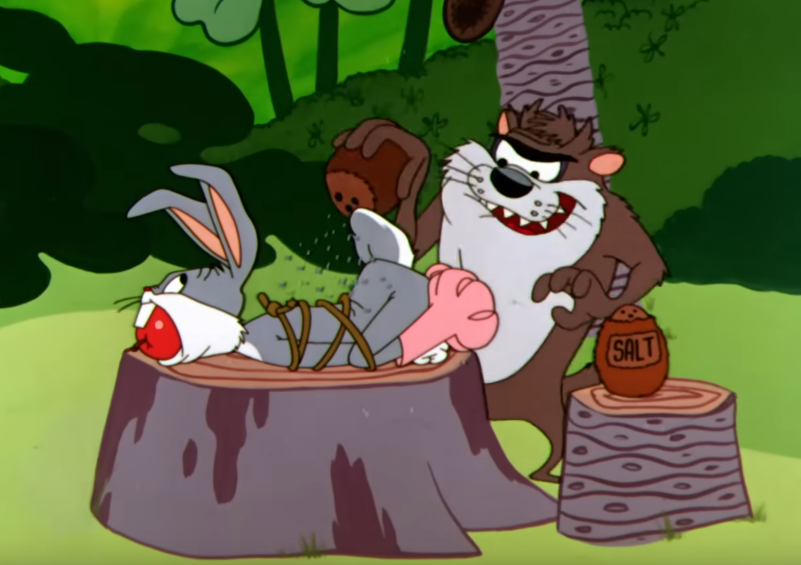 Cartoon screenshot of the Tasmanian Devil preparing a tied-up Bugs Bunny for dinner, sprinkling pepper onto Bugs trussed up like a Thanksgiving turkey.