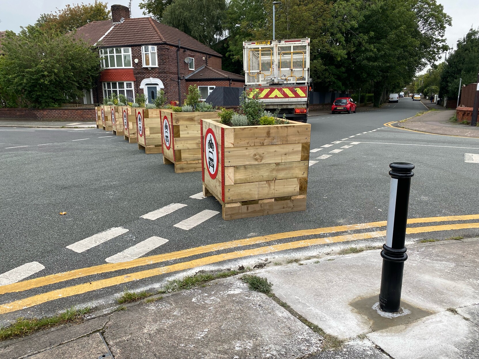 Bollards and planter boxes are natural allies (Withington, Greater Manchester)