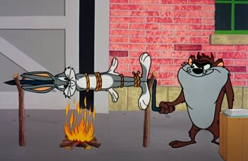 Cartoon screenshot of the Tasmanian Devil roasting Bugs Bunny on a spit over a fire.