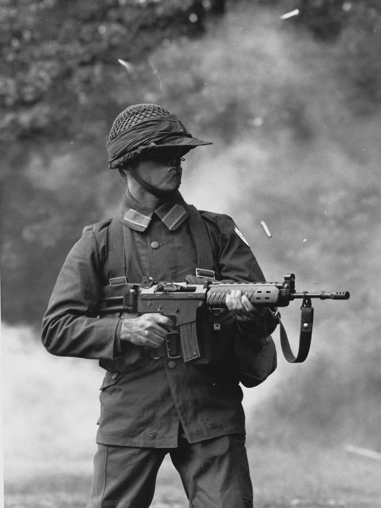 [750x1000] Swedish soldier firing an AK5