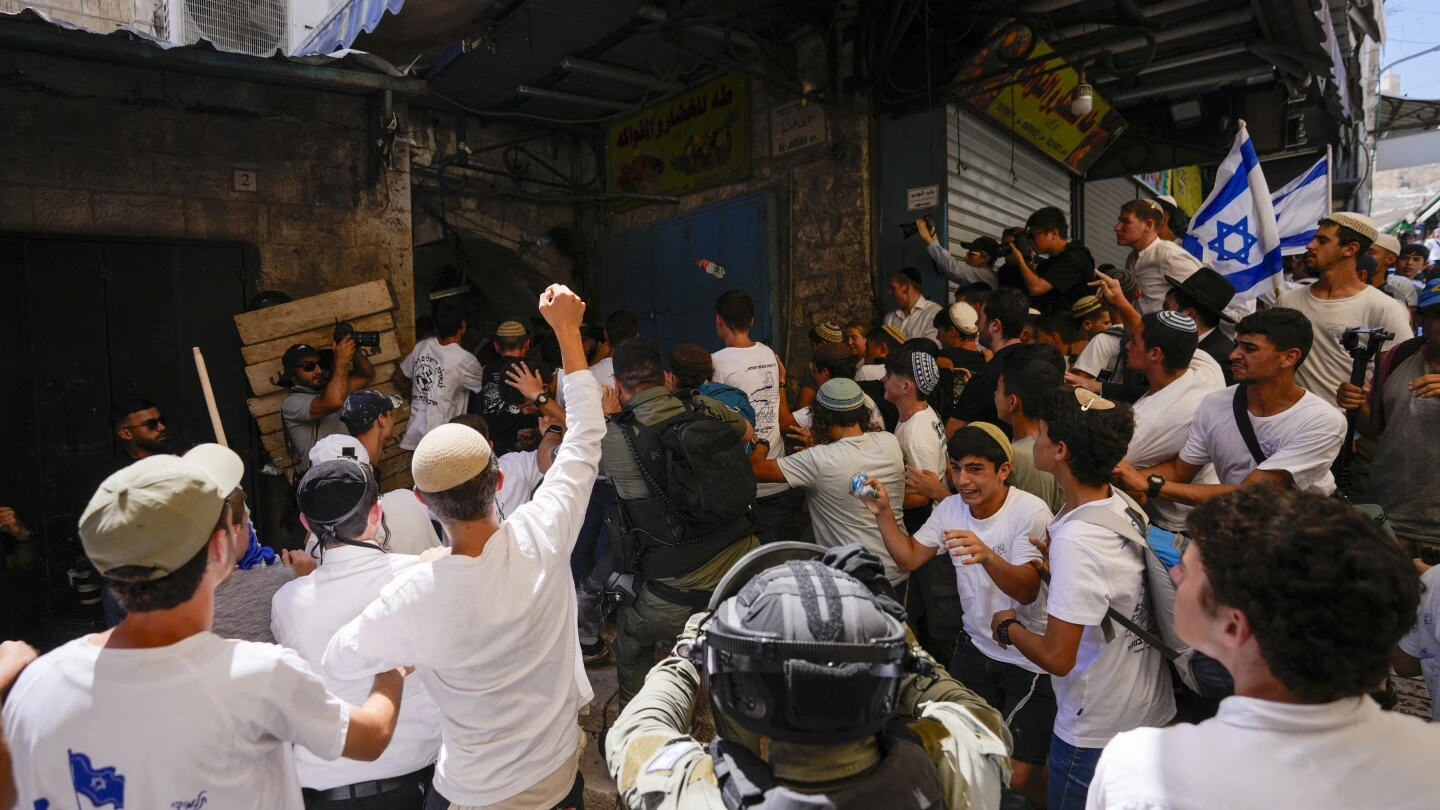 Israeli nationalists march through Palestinian area of Jerusalem, some chanting 'Death to Arabs'