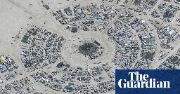 Burning Man festival-goers trapped in desert as rain turns site to mud
