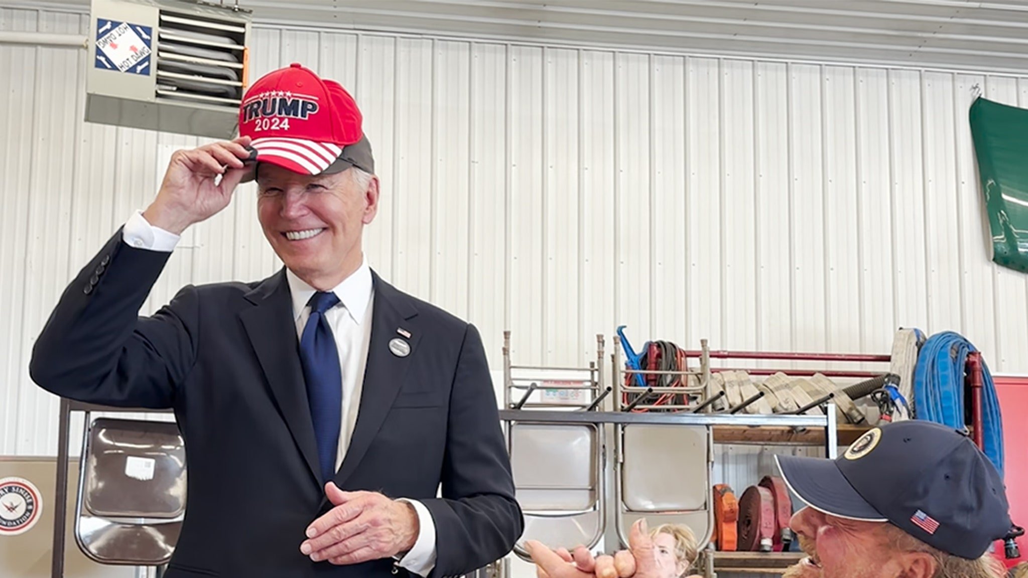 President Biden Banters With Trump Supporter Before Wearing MAGA Hat, New Video