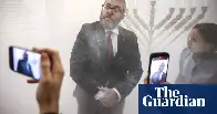 Far-right Polish MP uses fire extinguisher to put out Hanukah candles