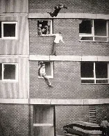 Some kids jumping out of windows onto mattresses for fun (England, 1980s)