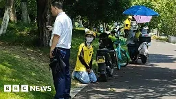 Protests in China as delivery rider kneels before security guard