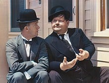Image of Laurel and Hardy, Laurel looking at Hardy while Hardy gazes wistfully into the distance.