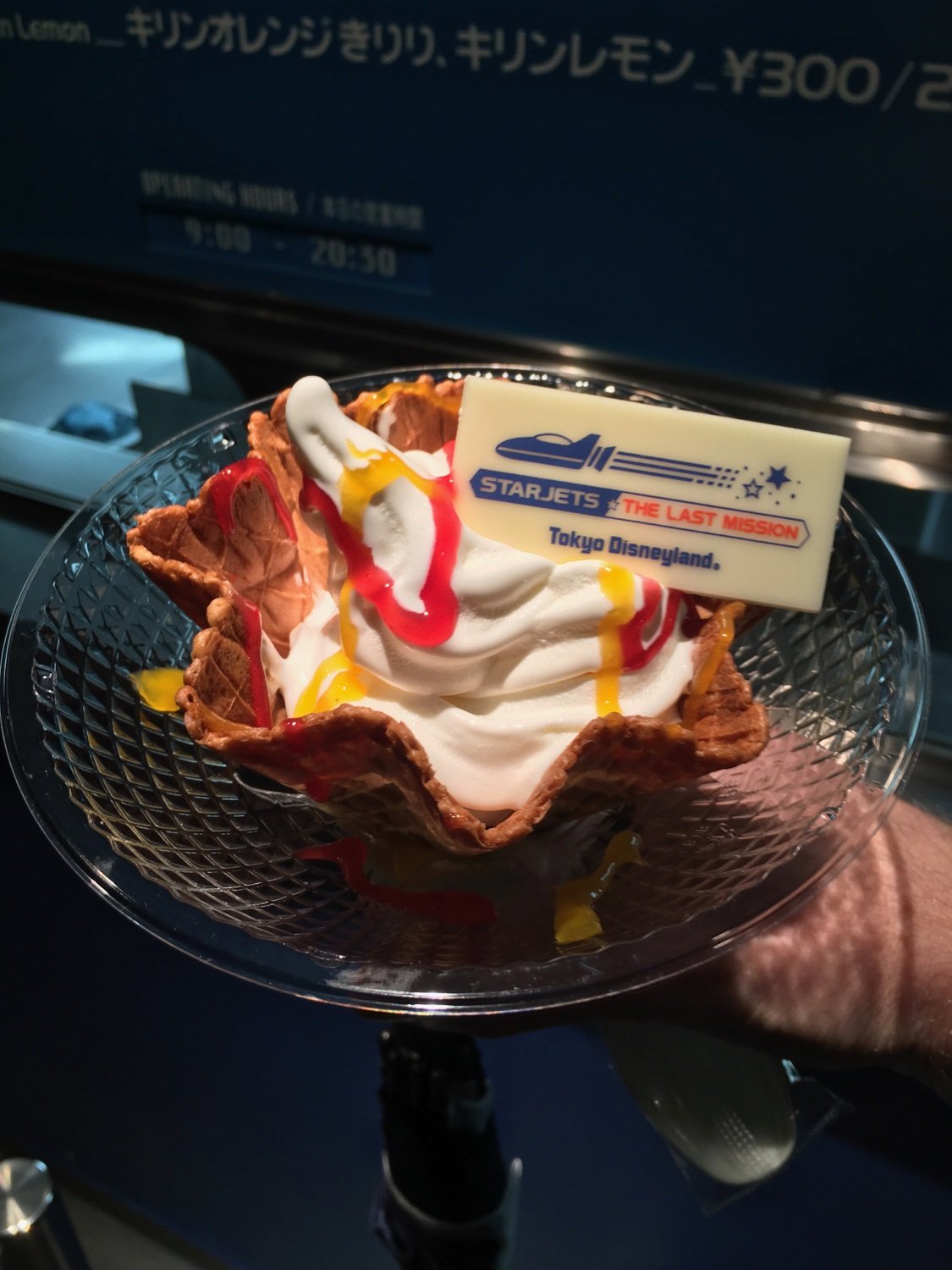 A handheld ice cream sundae featuring an edible card that reads "Starjets: The Last Mission".