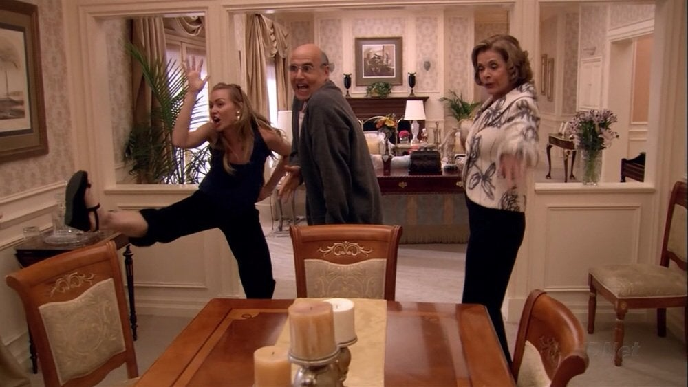 A scene from Arrested Development with multiple characters doing horribly inaccurate chicken impressions