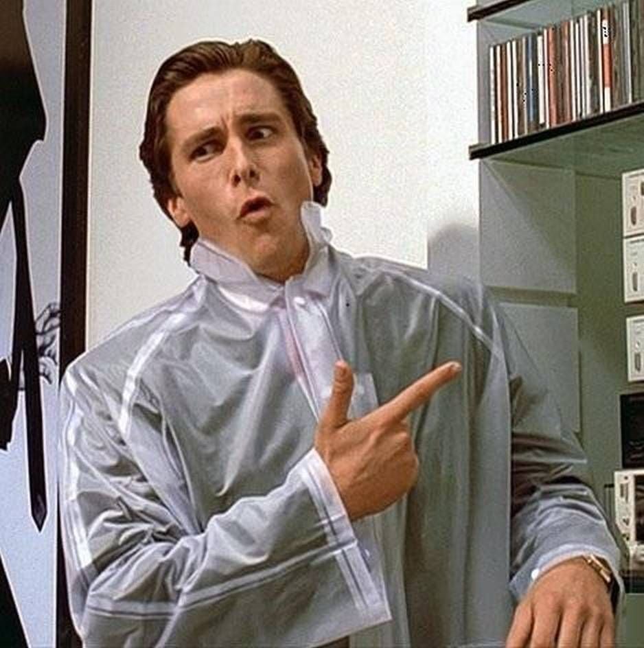 Christian Bale as Patrick Bateman in the movie American Psycho, wearing a clear raincoat and pointing to his stereo system while reciting trivia about Hewey Lewis and the News to his latest murder victim.