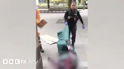 Police officer drags homeless man along ground - BBC News