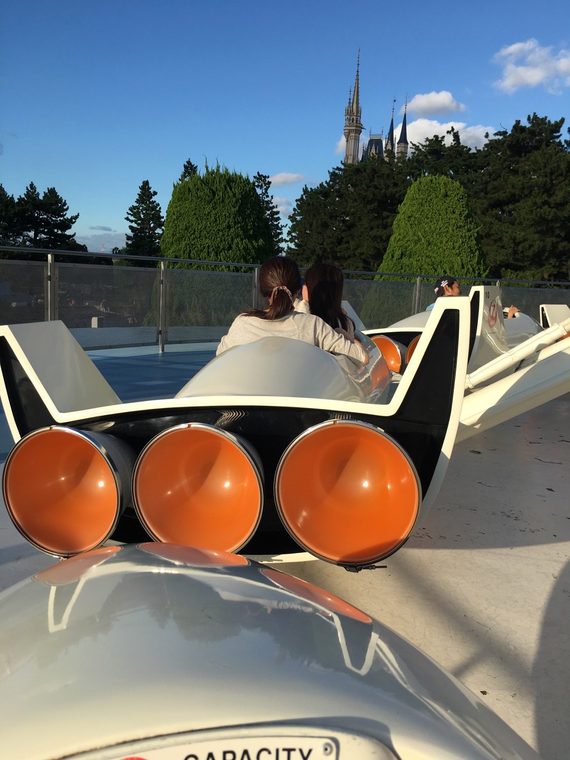 The elevated boarding area of Starjets just before the ride starts, other people are boarding their cars.